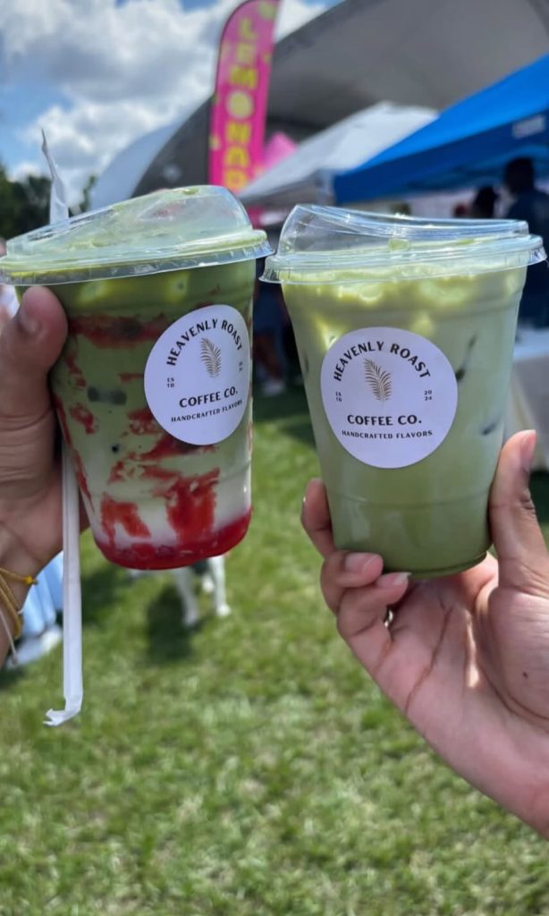 Two colorful Heavenly Roast drinks held up at an outdoor festival